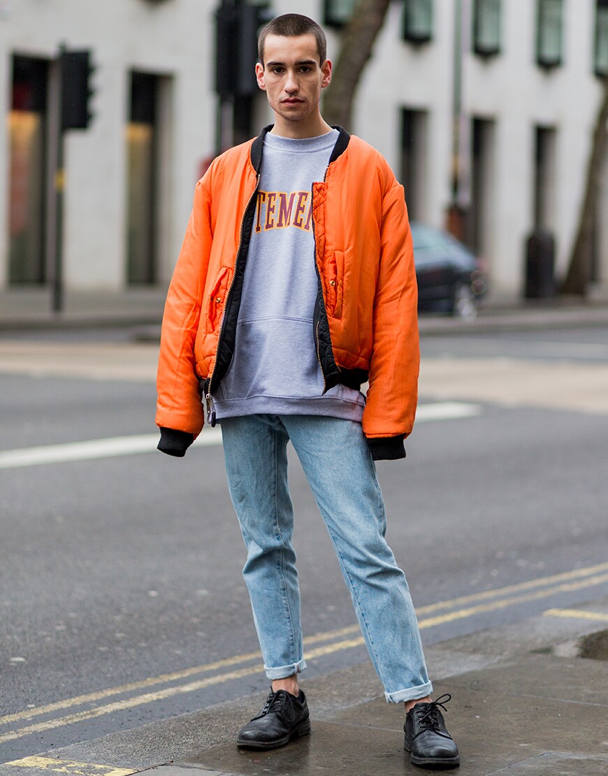 A street-styler wearing an emergency-orange coloured bomber jacket | ASOS Style Feed