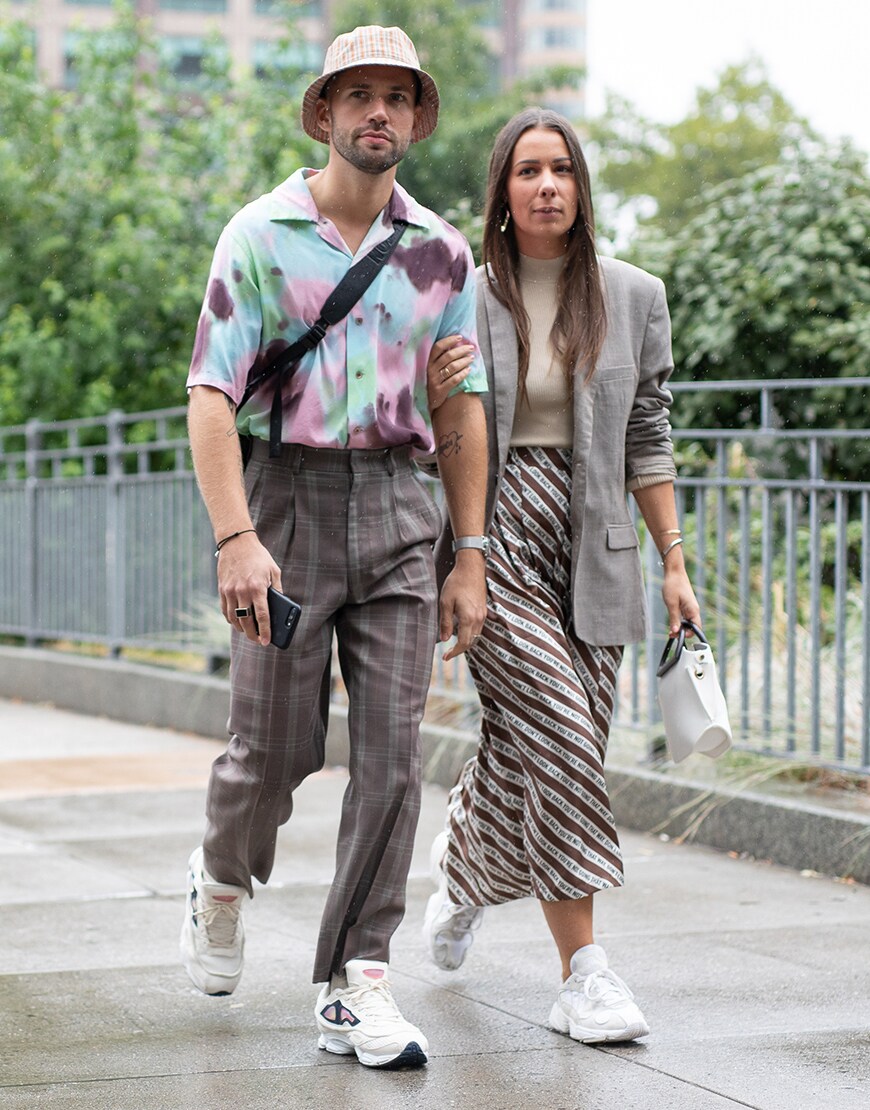 A street-styler wearing a check bucket hat, revere-collar shirt, check high-waister trousers and adidas Ozweego 2 trainers | ASOS Style Feed 