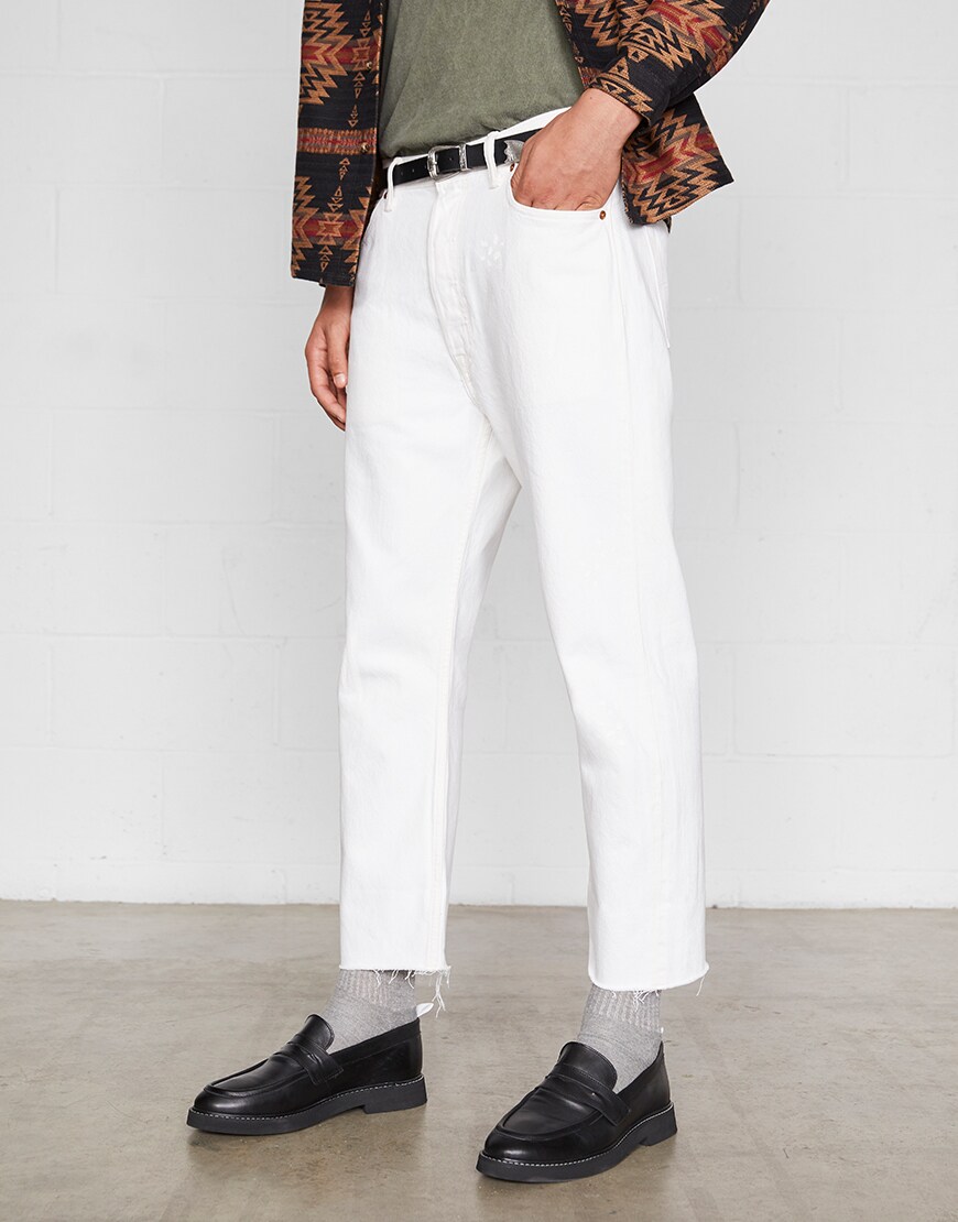 A model wearing white jeans, a western-inspired belt and loafers | ASOS Style Feed