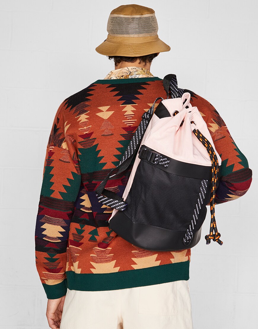 A model wearing a cardigan, two-tone rucksack and bucket hat | ASOS Style Feed