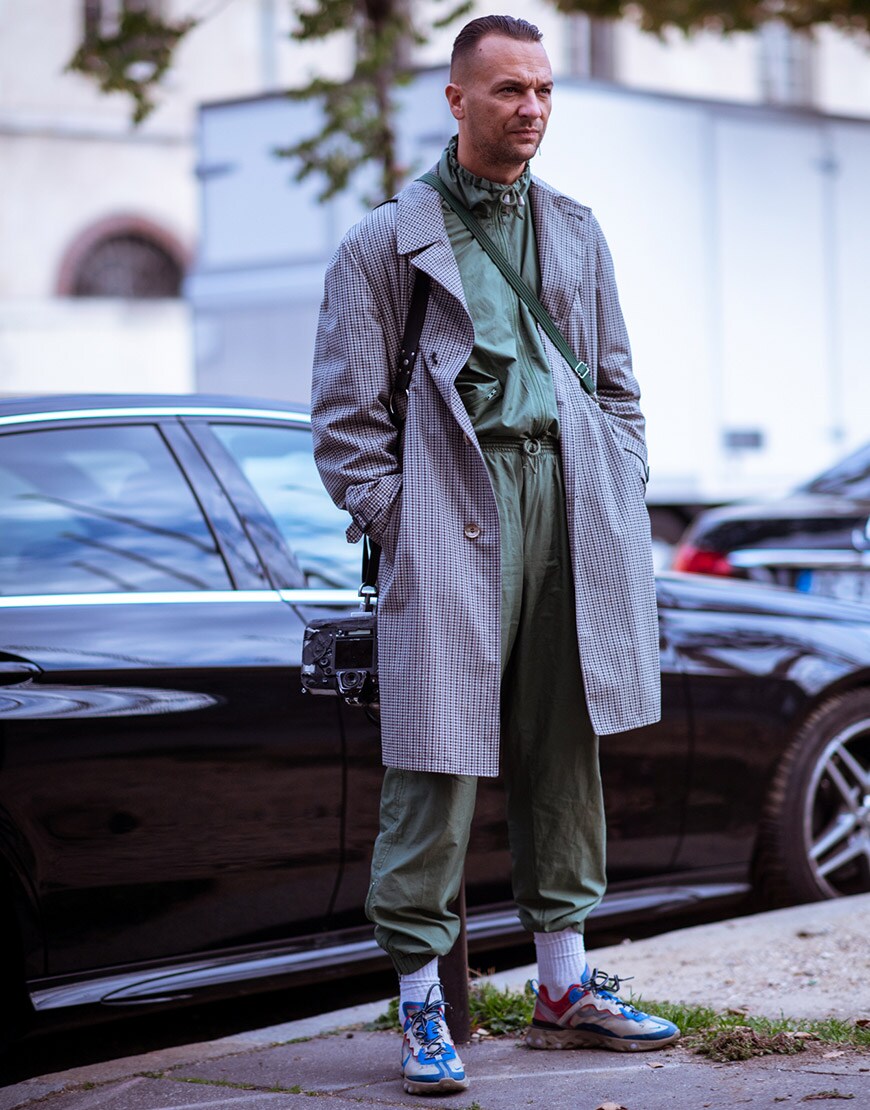 A street-styler wearing a check coat, a tracksuit and chunky trainers | ASOS Style Feed