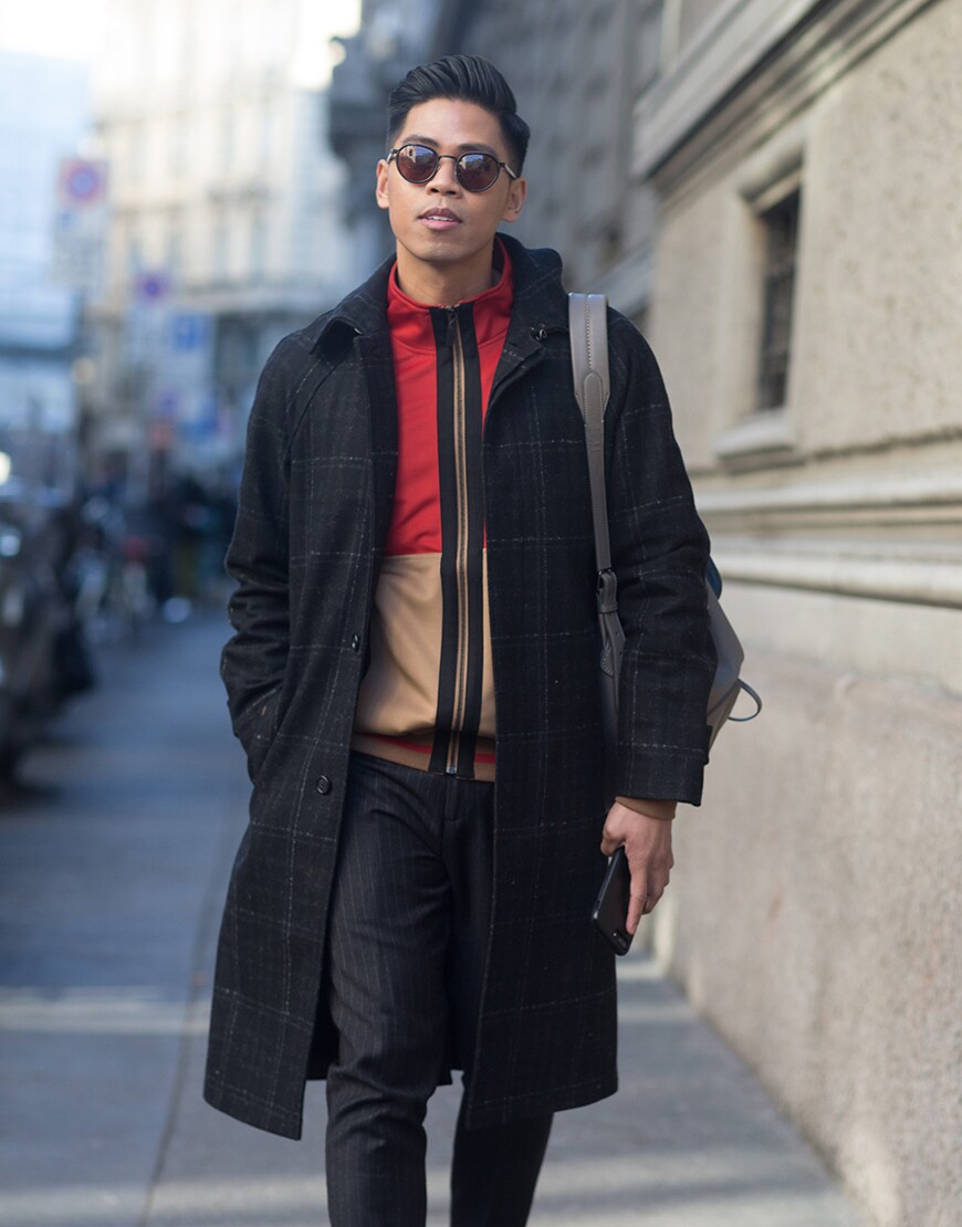 A street-styler wearing a check coat, track top and trousers | ASOS Style Feed
