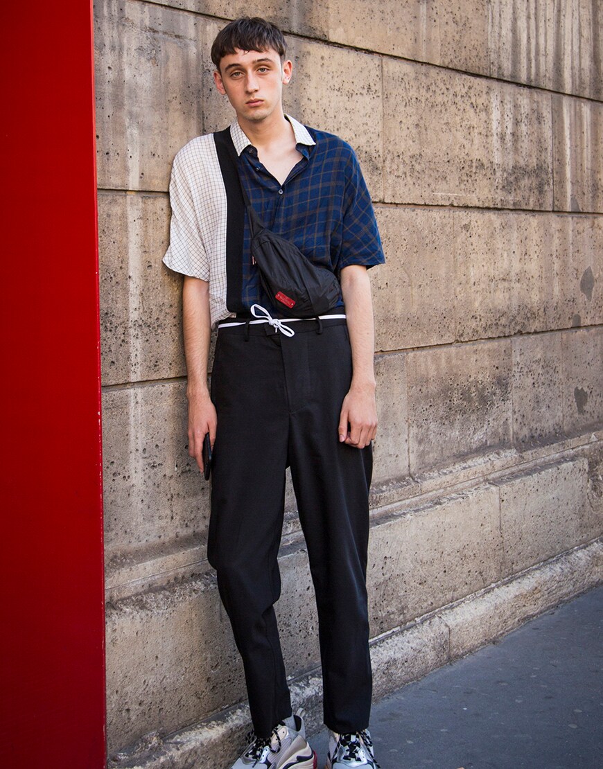 A street-styler wearing a check shirt, trousers and Balenciaga Triple S trainers | ASOS Style Feed