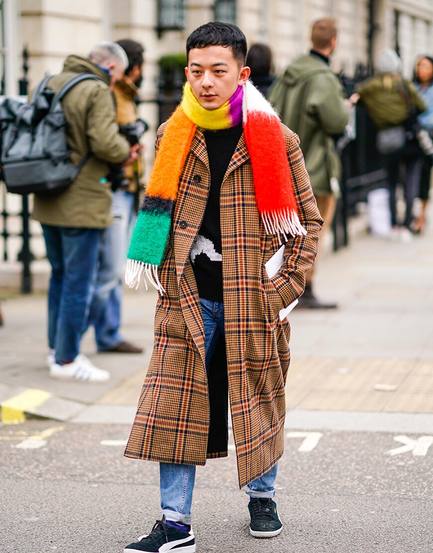 A street-styler in a traditional check coat and rainbow scarf | ASOS Style Feed
