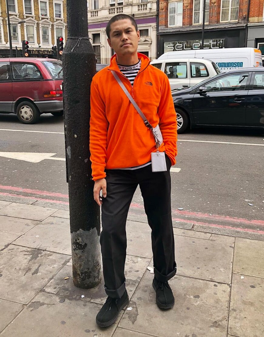 @asos_nawal wearing an orange The North Face half-zip fleece, a Stussy T-shirt, black trousers and black lace-up shoes available at ASOS | ASOS Style Feed