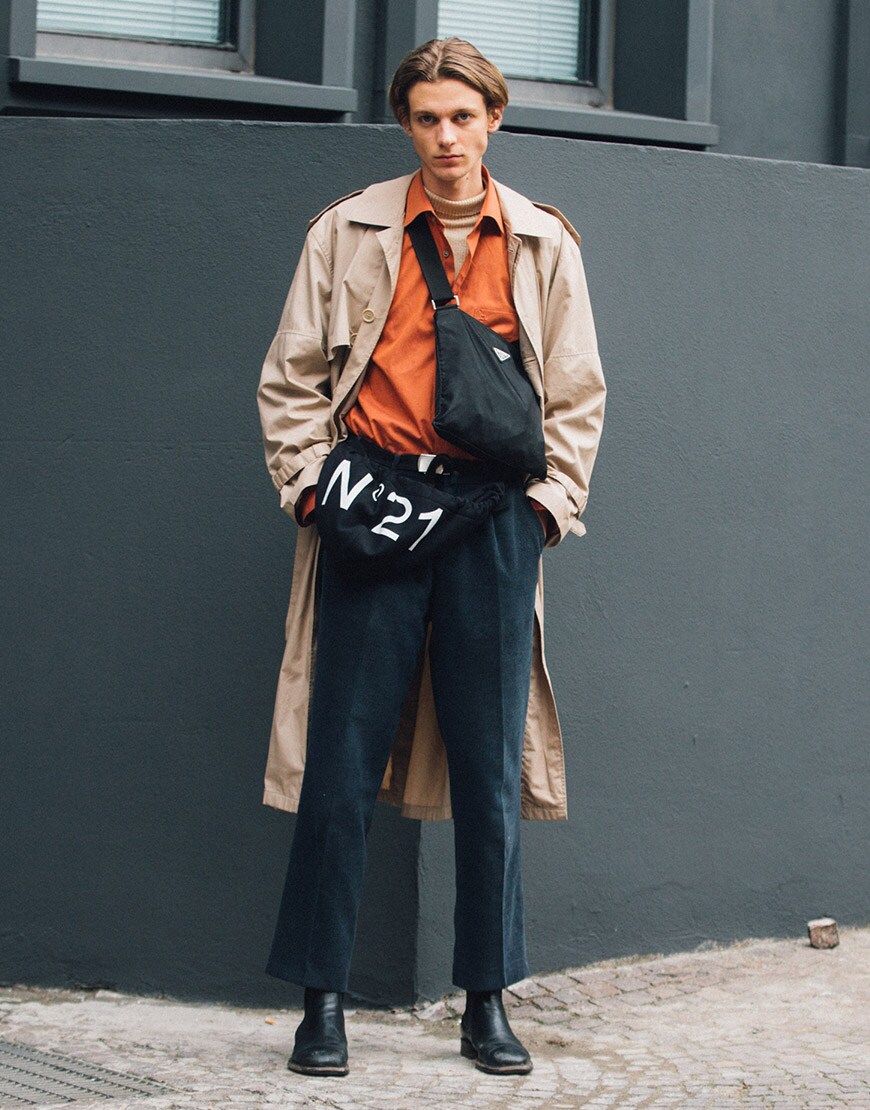 A street-styler wearing a roll-neck jumper, shirt, trousers, boots, cross-body bag and a trench coat | ASOS Style Feed