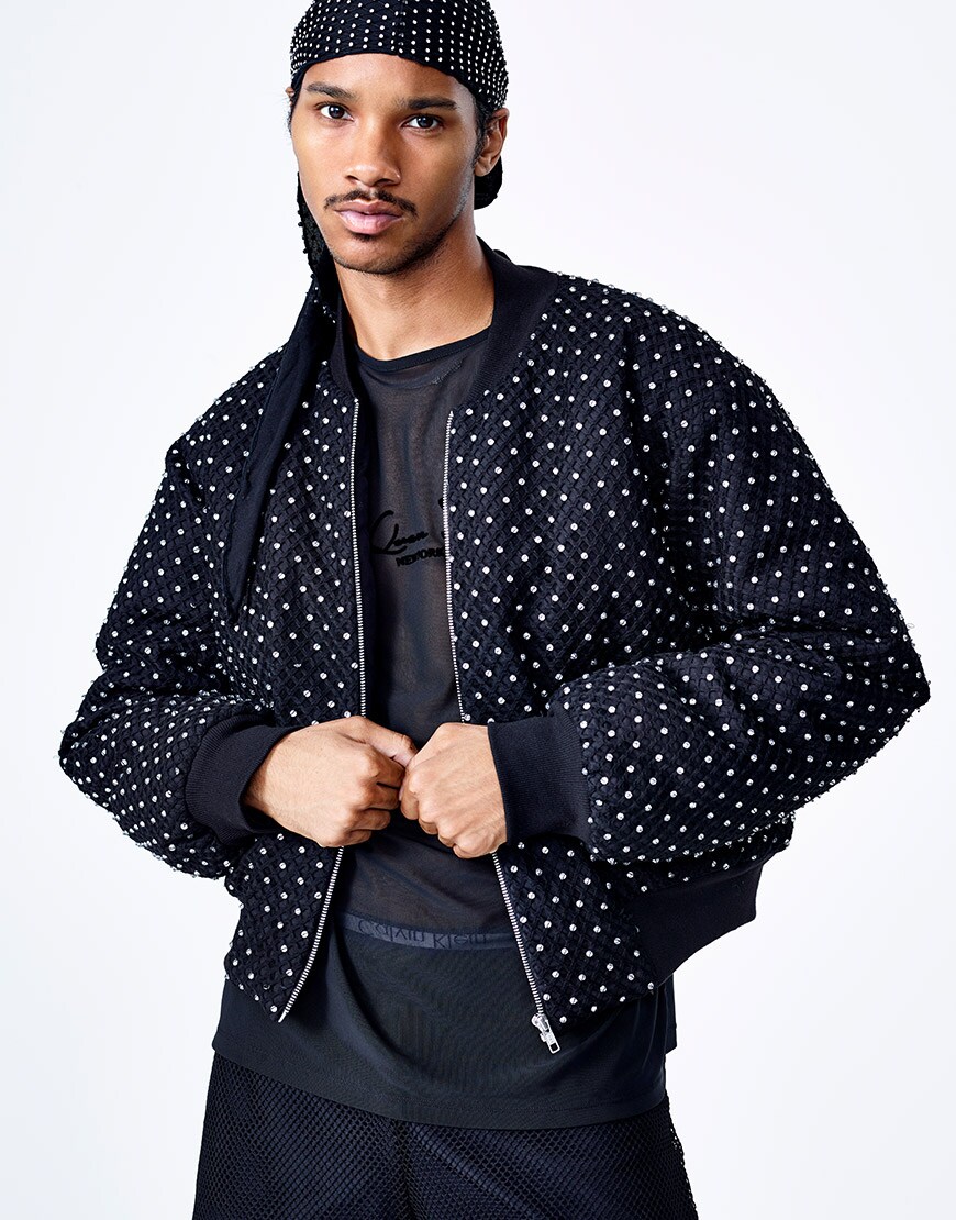 A model wearing a net T-shirt, studded du-rag and studded bomber jacket from the ASOS DESIGN x LaQuan Smith collection | ASOS Style Feed