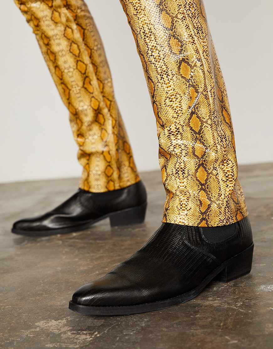 A close-up of a model wearing snakeskin trousers and black boots available at ASOS | ASOS Style Feed
