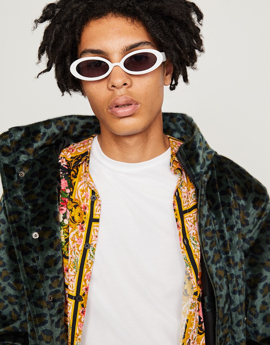 A model wearing sunglasses, a white T-shirt, a floral shirt and a leopard-print jacket available at ASOS | ASOS Style Feed