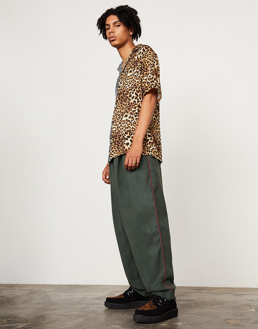 A model wearing an animal-print shirt, green trousers and black creepers available at ASOS | ASOS Style Feed