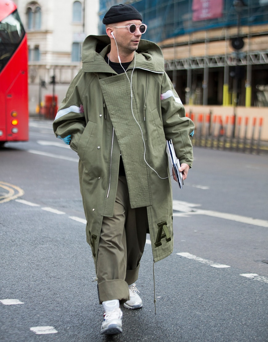 Street styler wearing a beanie, sunglasses and a khaki parka | ASOS Style Feed