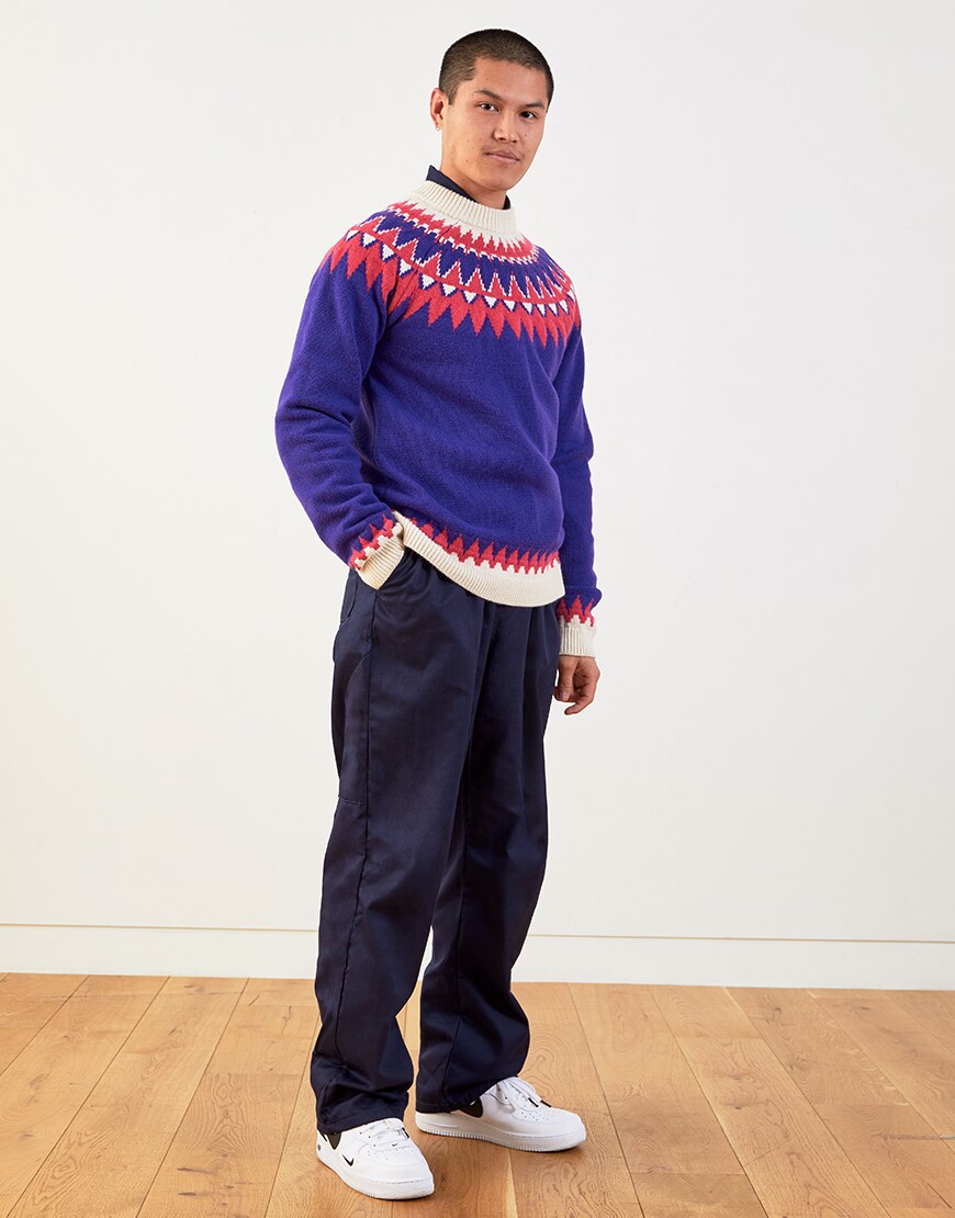 Nawal wearing a knitted jumper, blue trousers and Nike Air Force 1 trainers | ASOS Style Feed