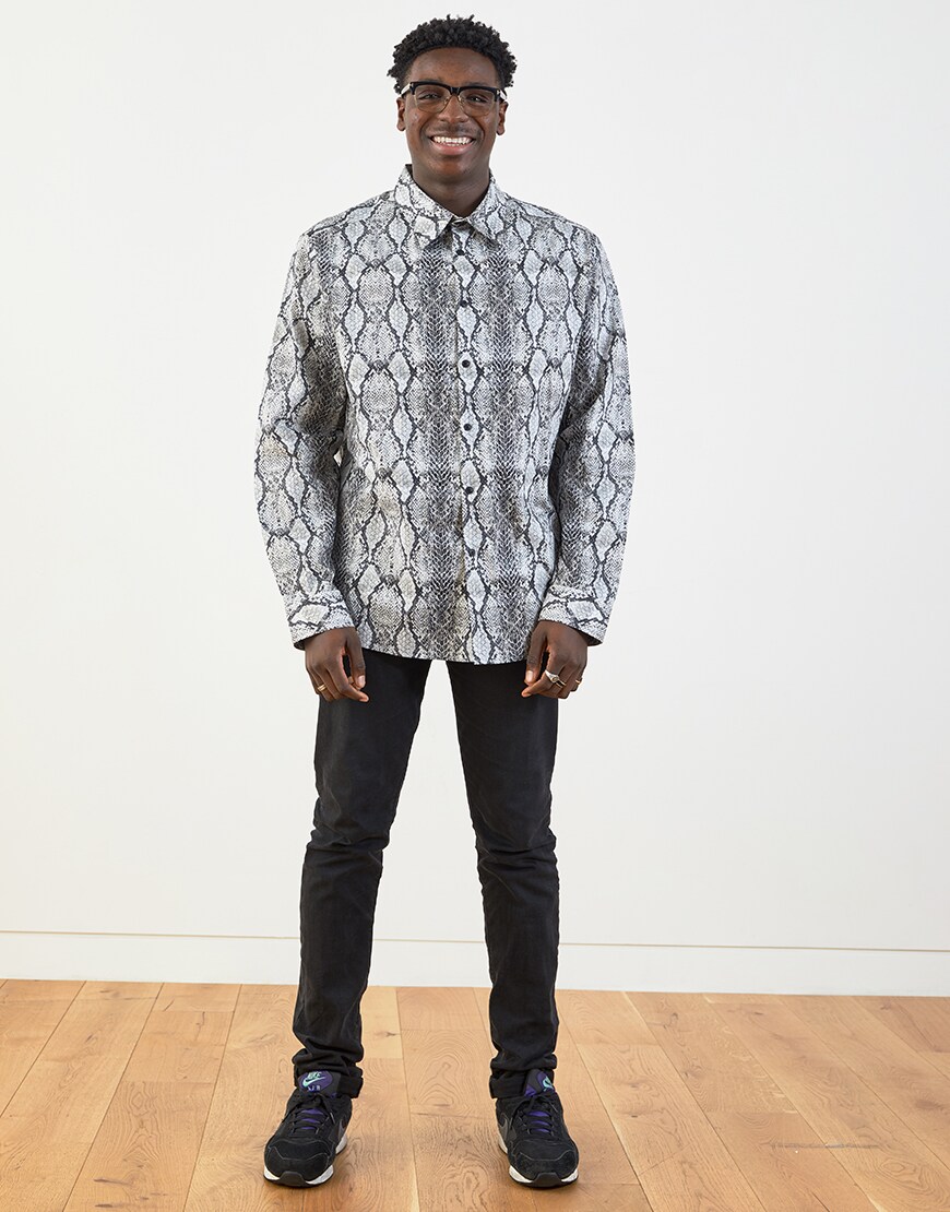 Babatunde wearing a snake-print shirt, black jeans and Nike trainers | ASOS Style Feed