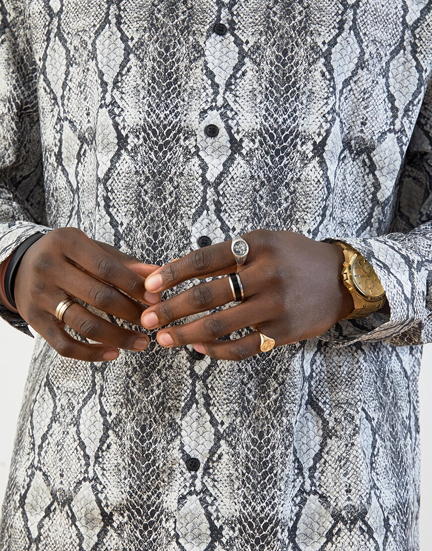 A close-up of Babatunde's snake-print shirt and rings | ASOS Style Feed