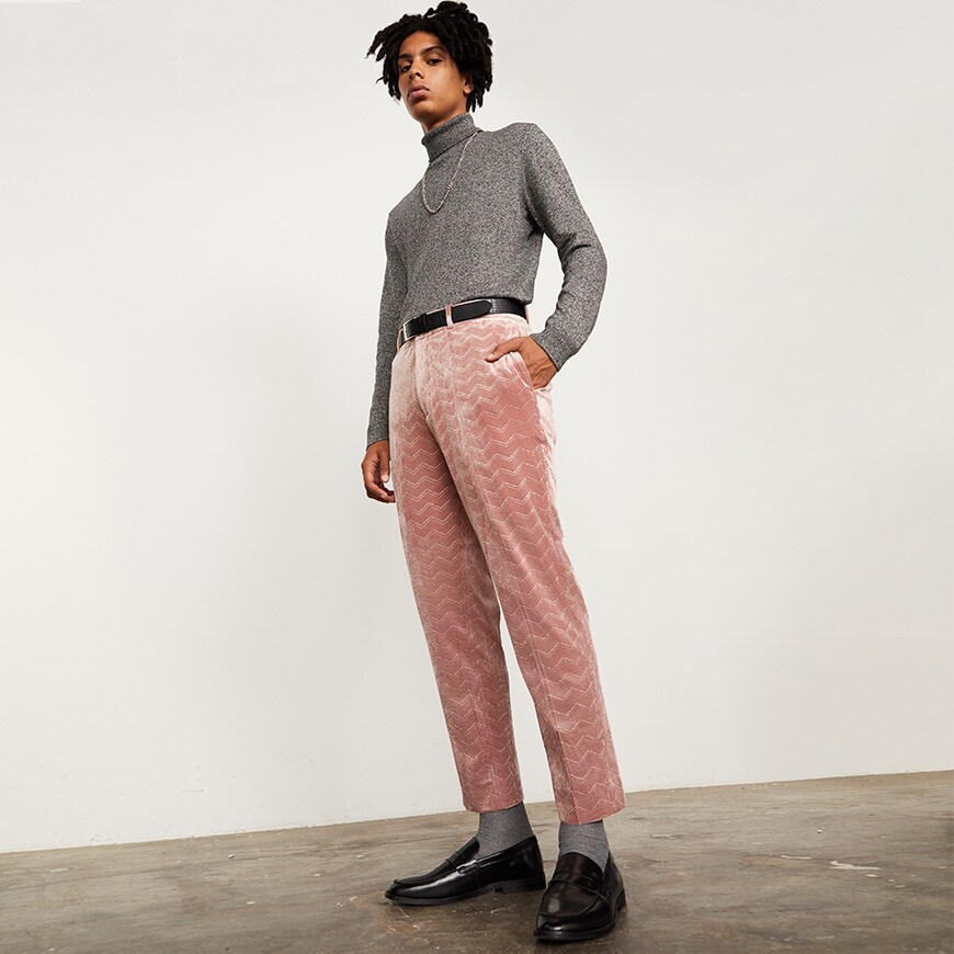 A model wearing a grey polo-neck top with pink corduroy trousers | ASOS Style Feed