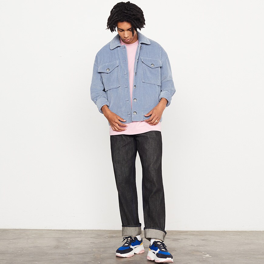 A model wearing a pink T-shirt, blue corduroy jacket, jeans and chunky trainers | ASOS Style Feed