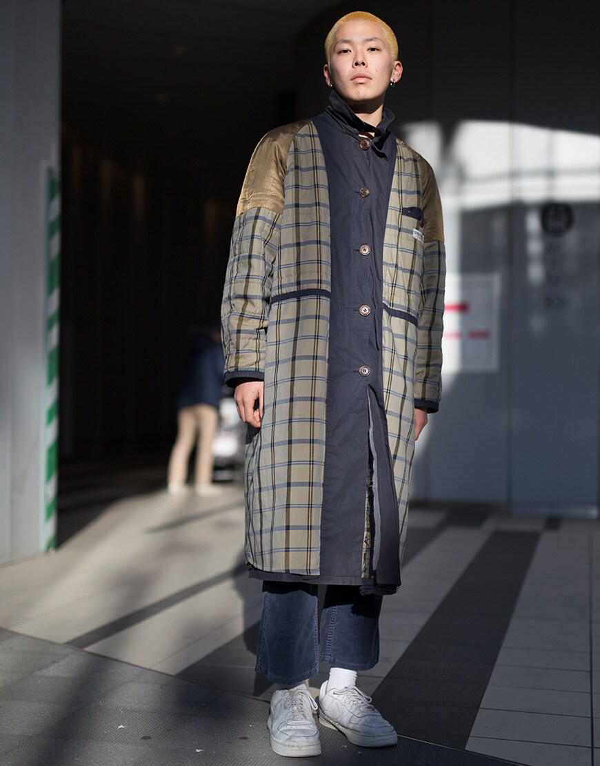 A street-styler wearing a longline check coat, jeans and Nike Air Force 1s | ASOS Style Feed