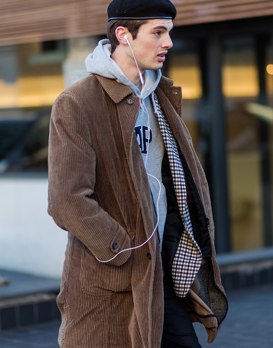 A street-styler wearing a grey hoodie, corduroy coat and beret | ASOS Style Feed