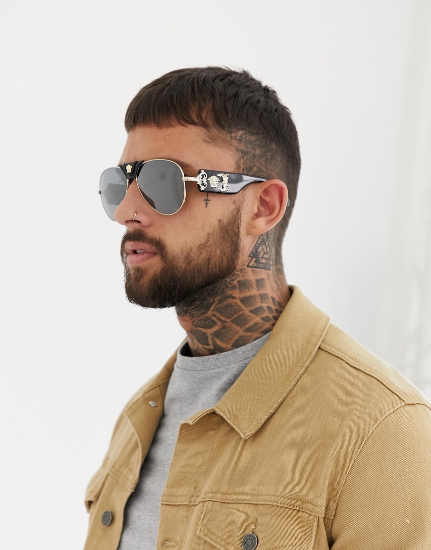 Man wearing black and gold sunglasses