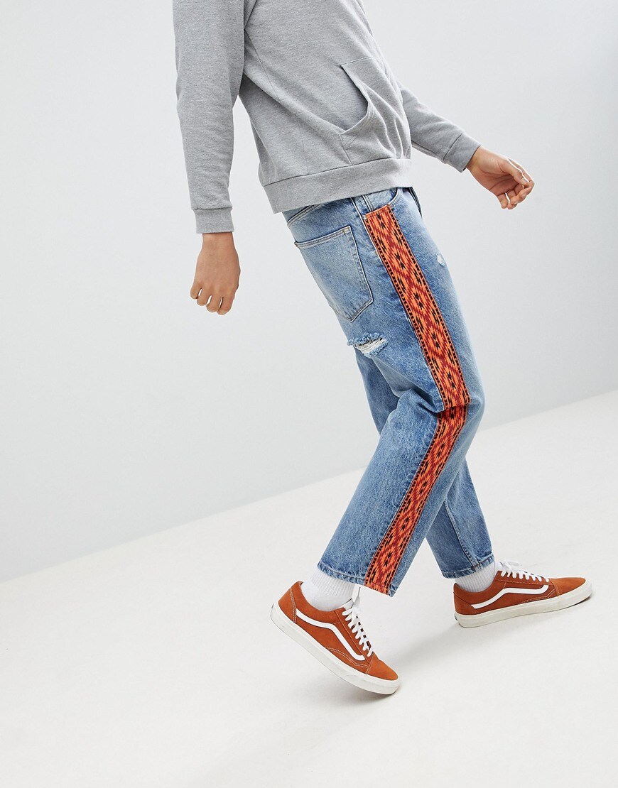 Light wash skater fit jeans with contrast side taping available at ASOS