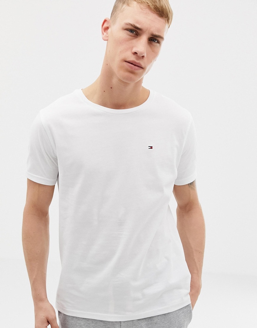 A picture of a model wearing an organic cotton T-shirt by Tommy Hilfiger. Available at ASOS.