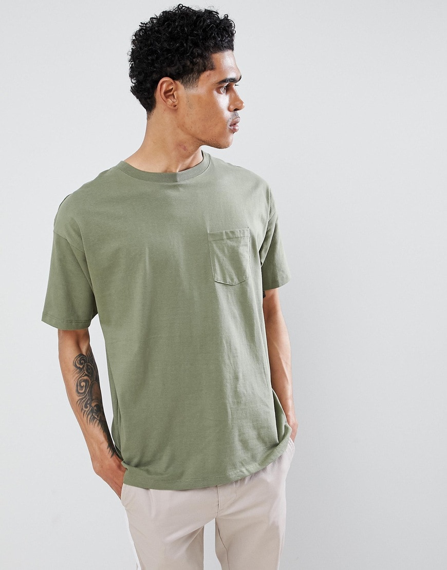 A picture of a model wearing a khaki T-shirt made from organic cotton. Available at ASOS