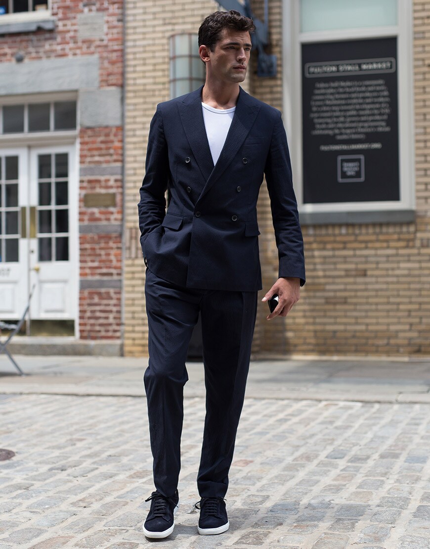 A street-styler wearing a suit with trainers | ASOS Style Feed