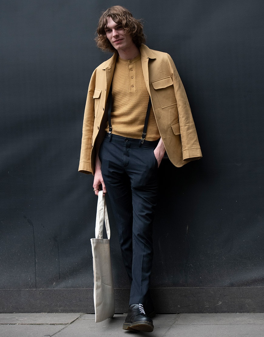 A street-styler wearing a knitted Henley top, Utility jacket and trousers | ASOS Style Feed
