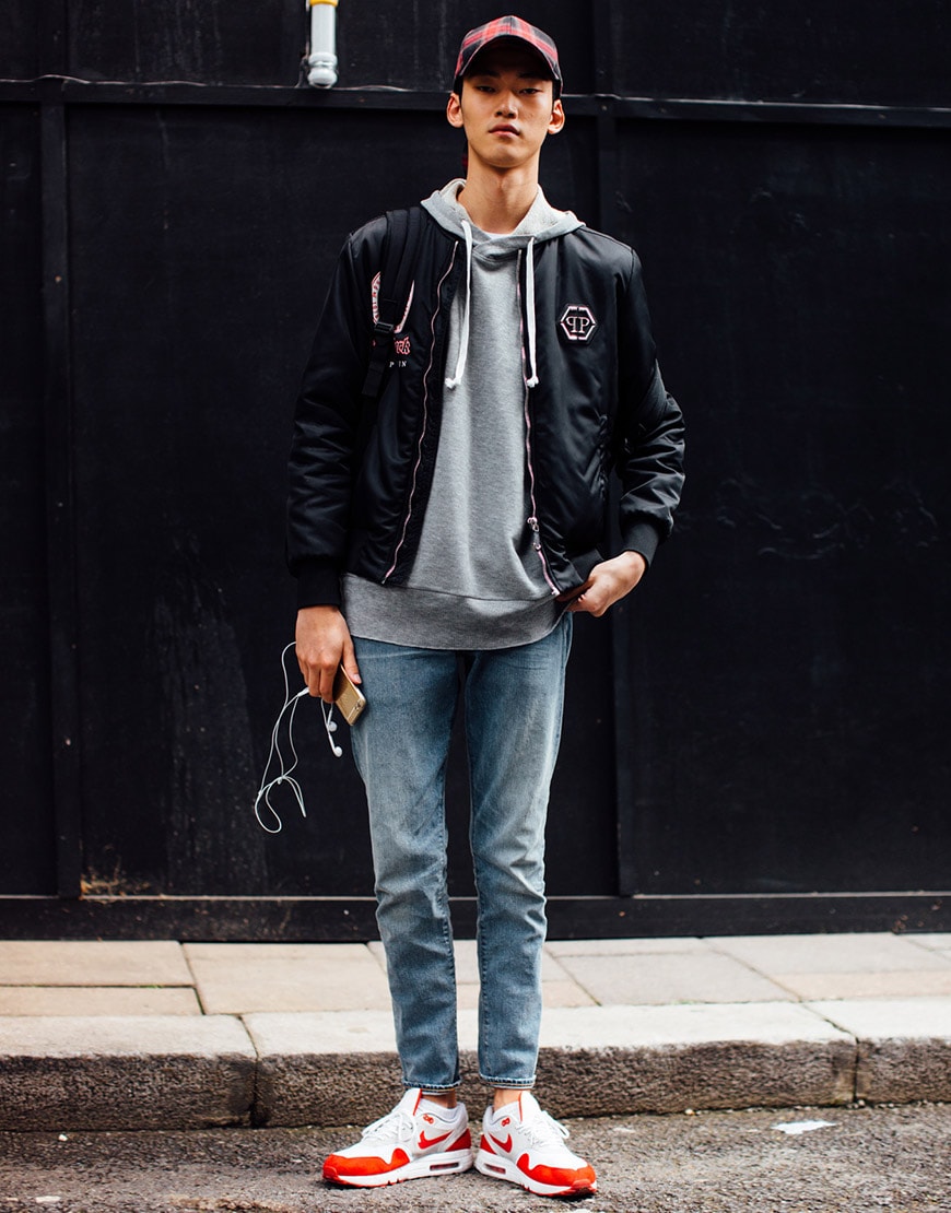 A street-styler wearing a grey hoodie, jeans, cap, leather jacket and Nike Air Max 1 trainers | ASOS Style Feed