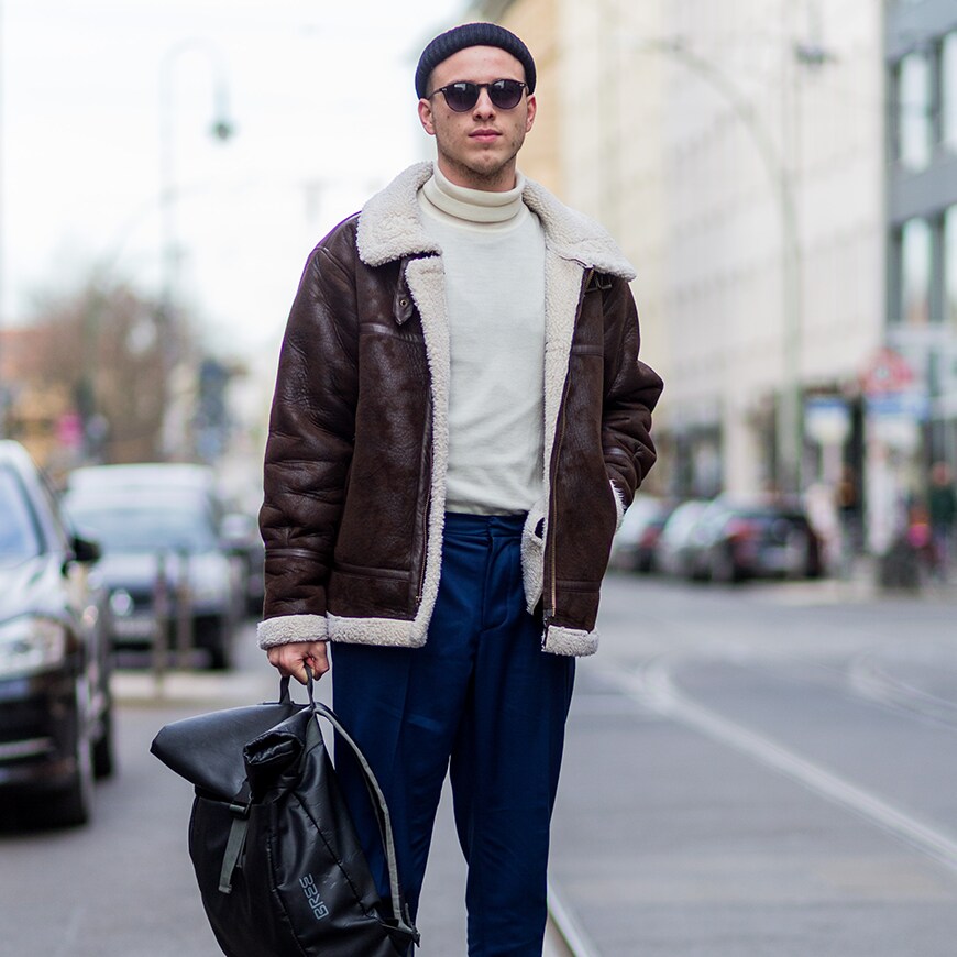 A still of a street-styler wearing a polo neck, brown leather jacket and navy chinos | ASOS Style Feed