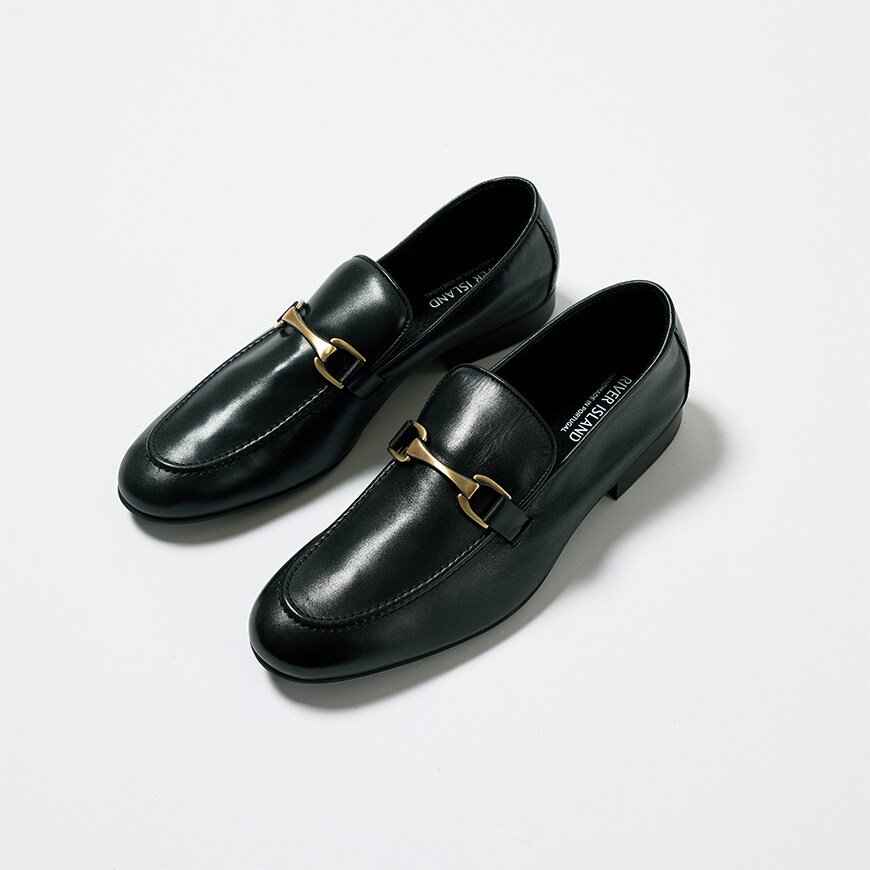 A pair of black loafers with a gold buckle from River Island, available on ASOS.