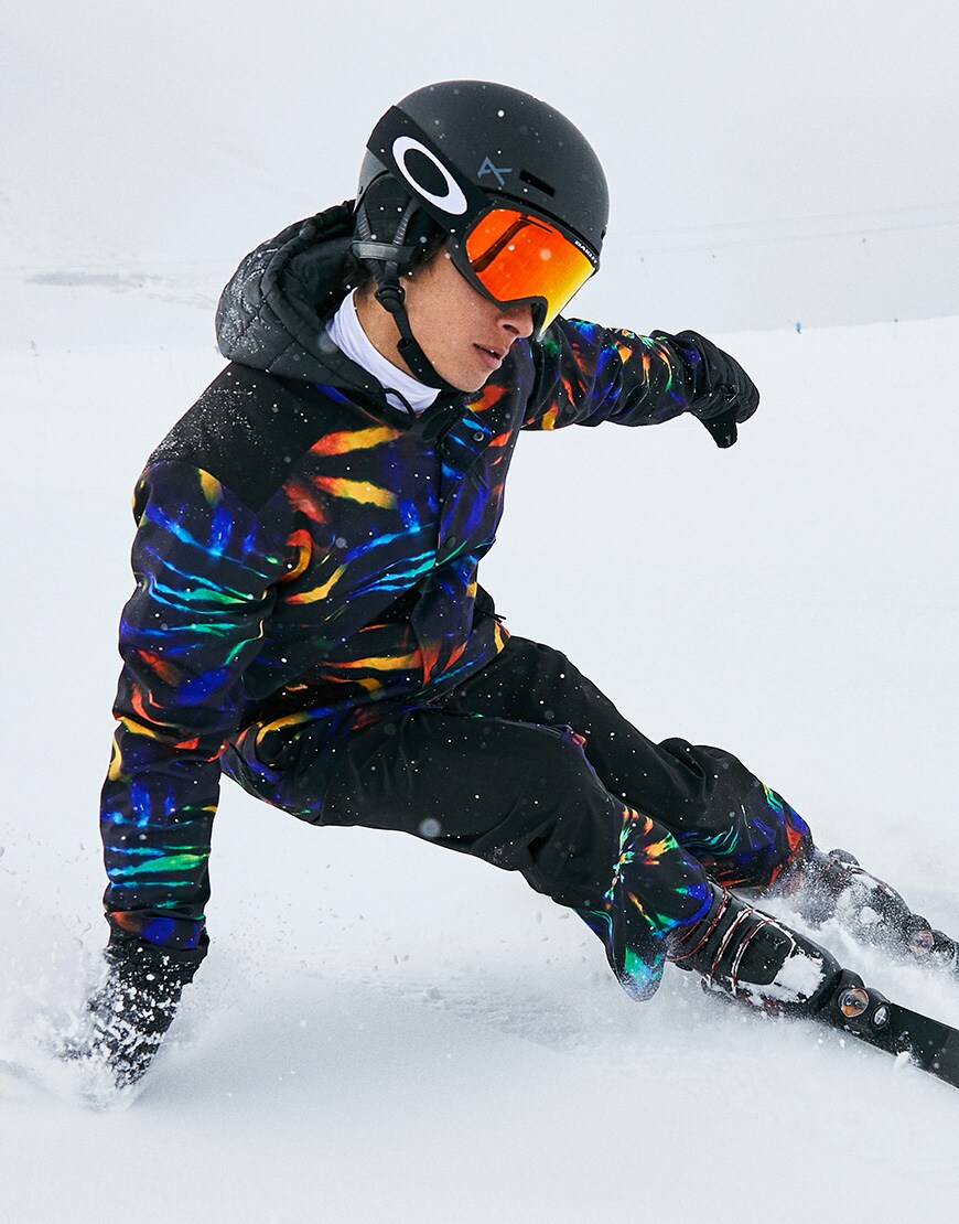 A picture of a man skiiing wearing a tie-dye ski suit by ASOS 4505. Available on ASOS.