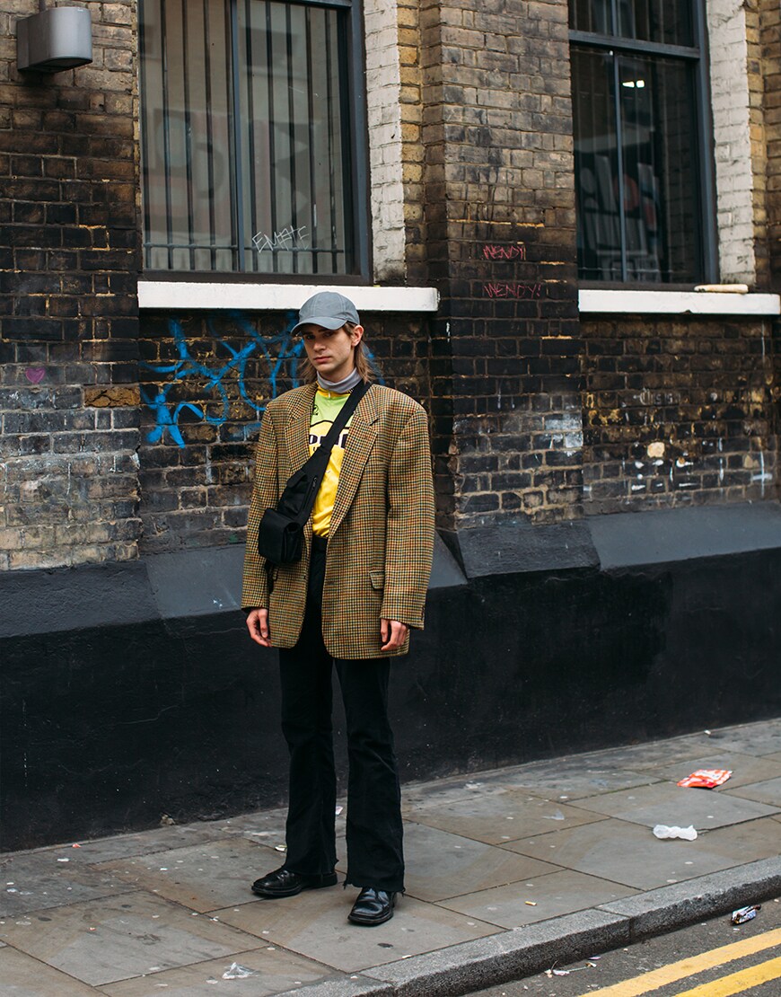 London street-styler wearing a check blazer with a neon T-shirt | ASOS Style Feed