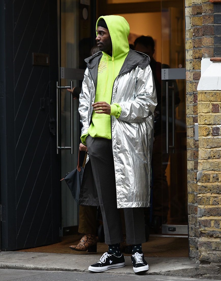 London street-styler wearing a neon green hoodie and longline silver coat | ASOS Style Feed