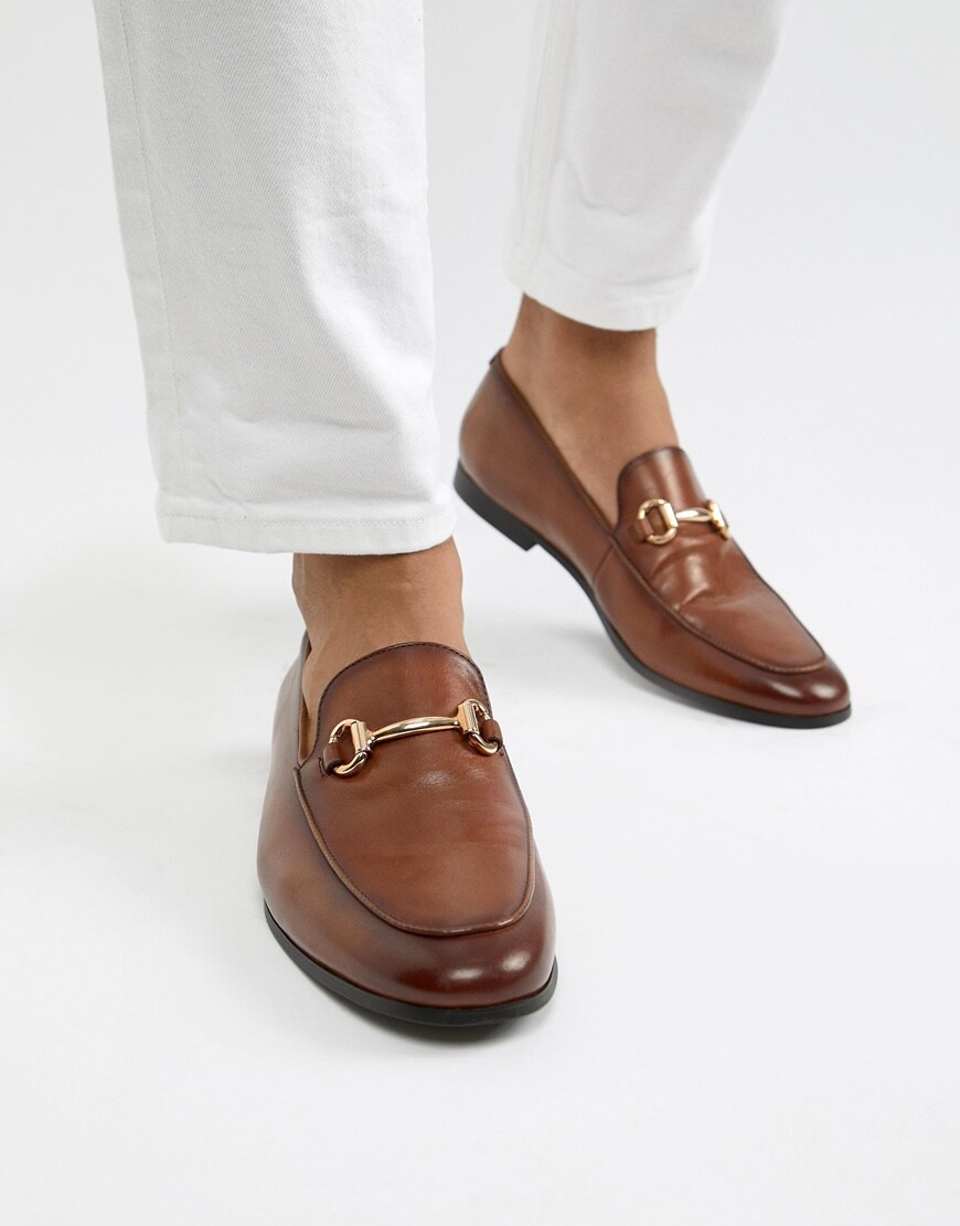 A picture of a man wearing brown loafers from River Island. Available at ASOS.