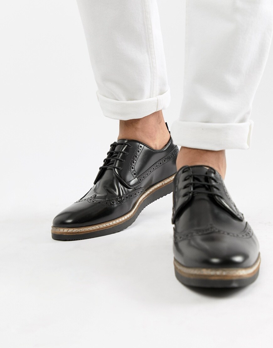 A picture of a pair of black brogues with a small wedge sole by ASOS DESIGN. Available on ASOS.
