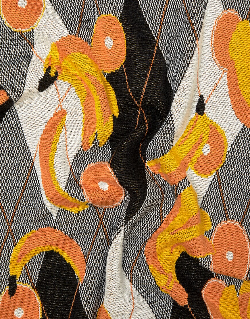A close up picture of a knitted, short sleeve top featuring a diamond and fruit design. Available on ASOS.
