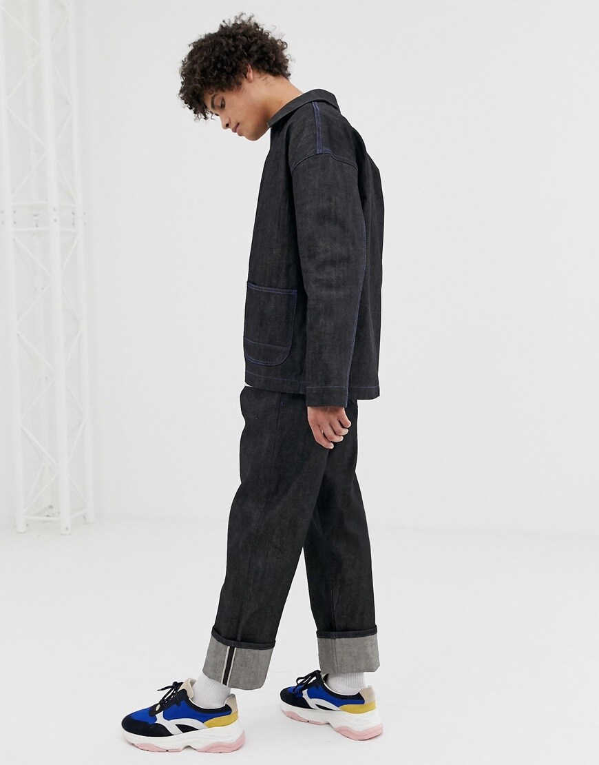 A picture of a man wearing an indigo denim co-ord from ASOS WHITE. Available at ASOS.