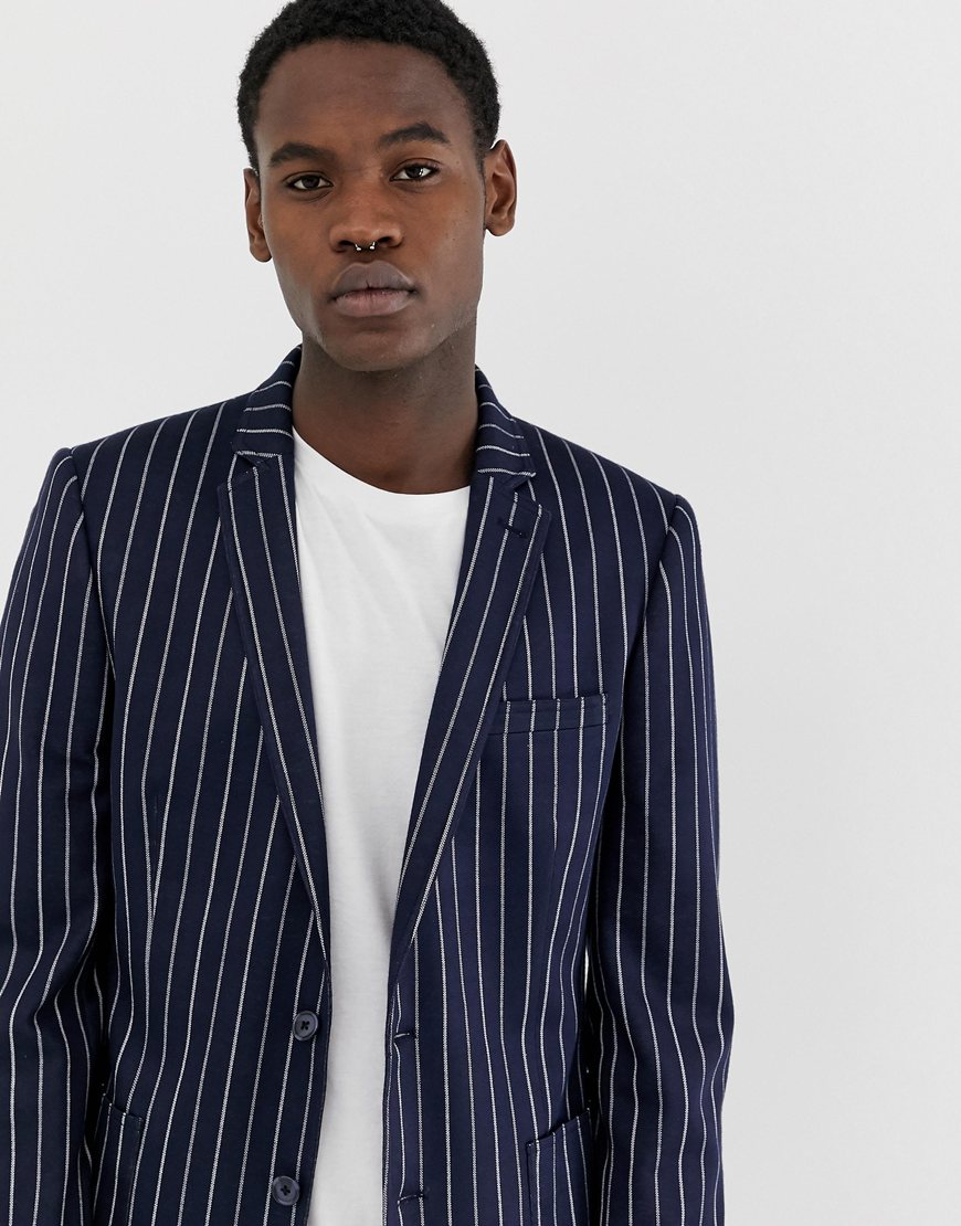 A picture of a man wearing a navy pinstripe, jersey blazer by ASOS DESIGN.  Available on ASOS.
