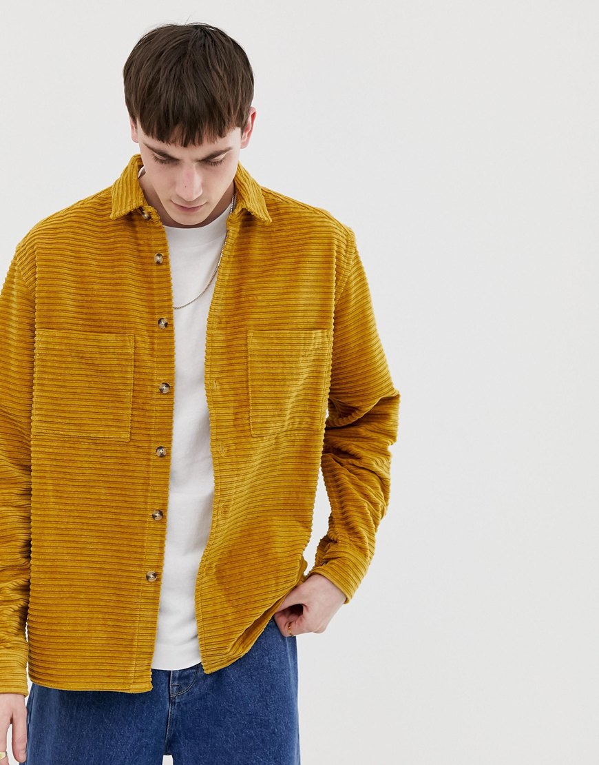 A picture of a man wearing a mustard overshirt. Available at ASOS.