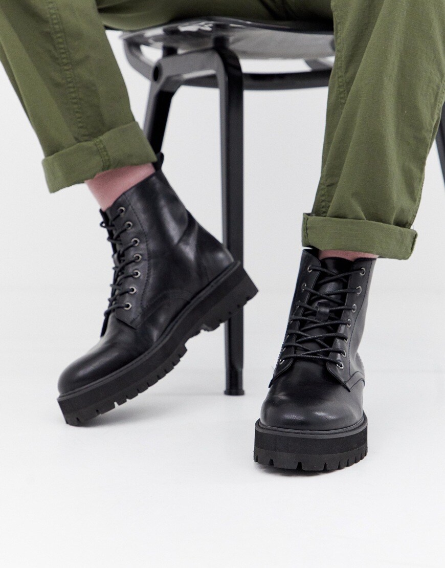 A picture of a pair of black boots with chunky, cleated soles. Available at ASOS.