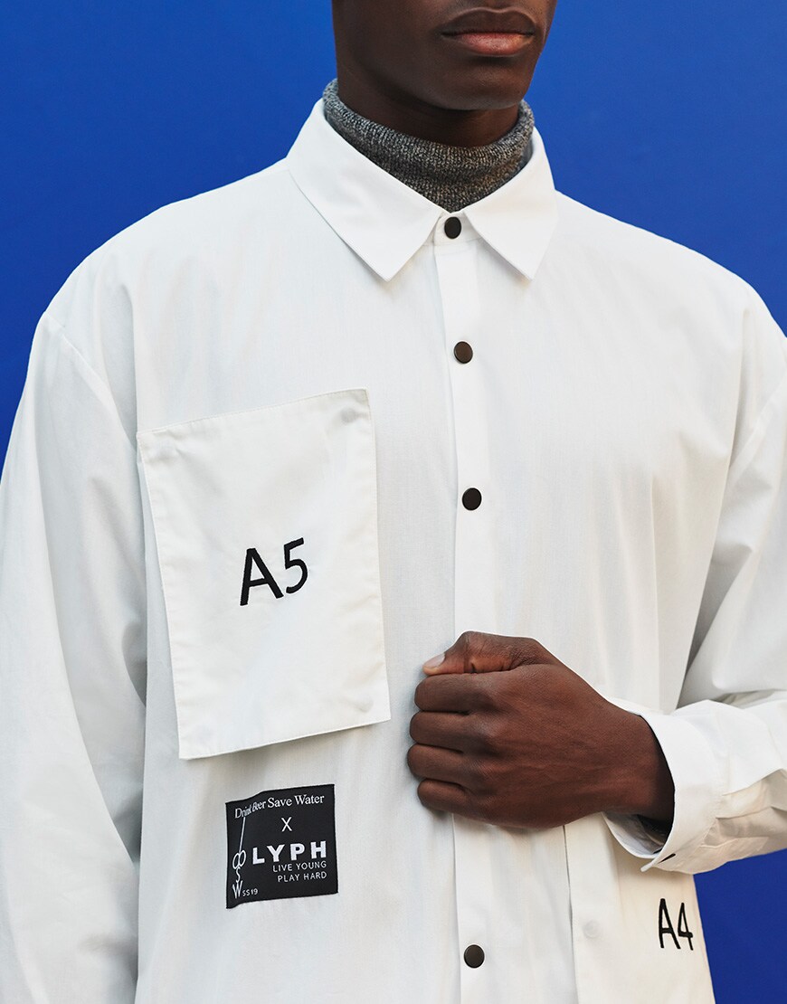 A picture of a man wearing a white shirt and pants by LYPH. Available on ASOS.