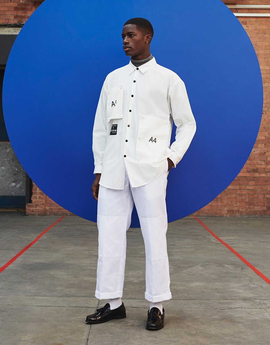 A picture of a man wearing a white shirt and trousers by LYPH. Available on ASOS.