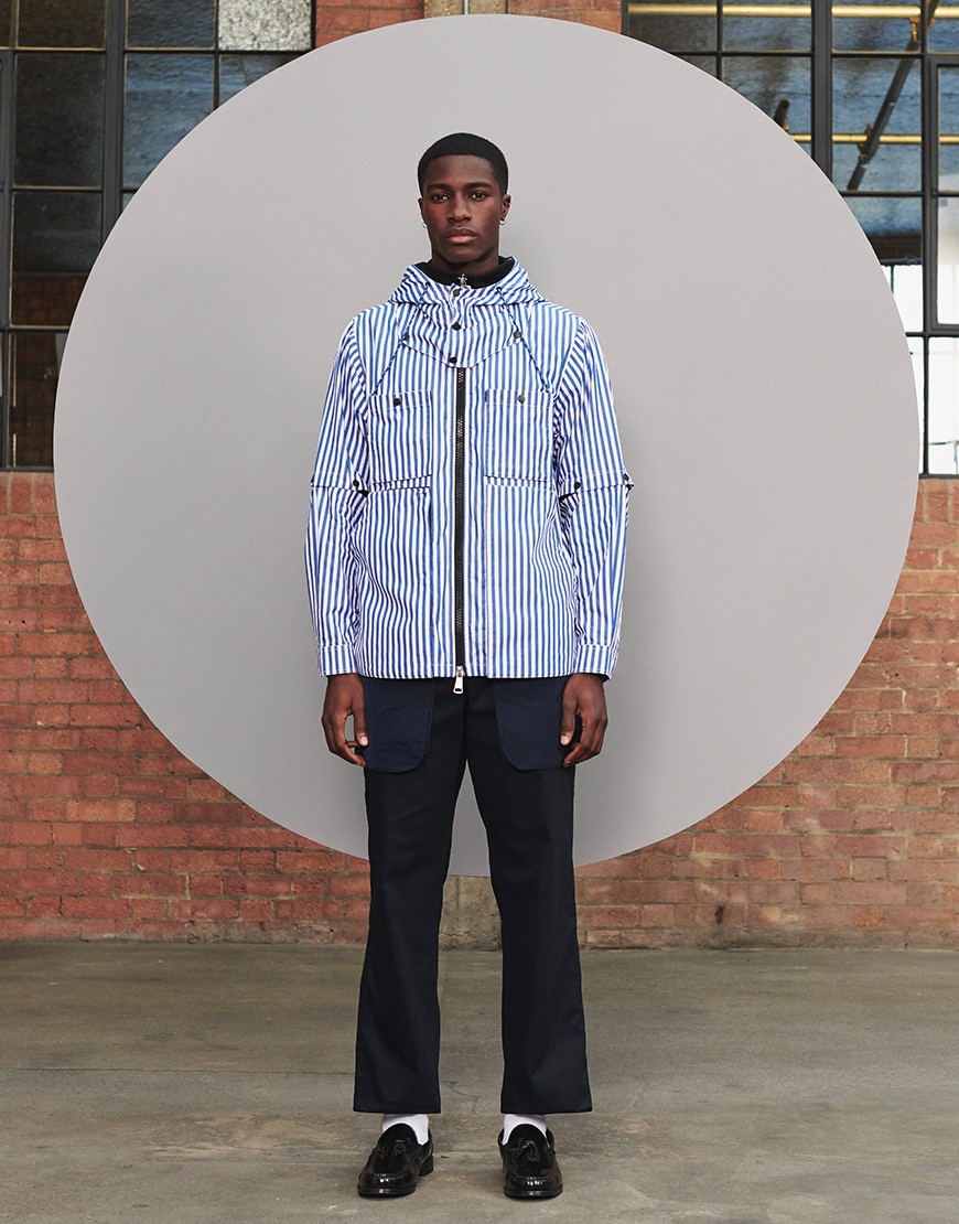 A picture of a man wearing a blue and white striped jacket and navy flared trousers by LYPH. Available on ASOS.