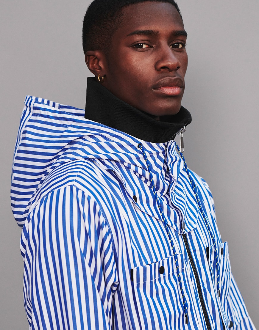 A picture of a man wearing a blue and white striped jacket and navy flared trousers by LYPH. Available on ASOS.