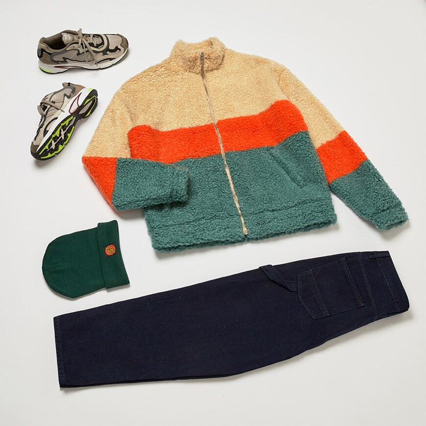 A flat lay of a midwinter outfit including a borg jacket, a beanie, skater fit jeans and adidas trainers. All available at ASOS.