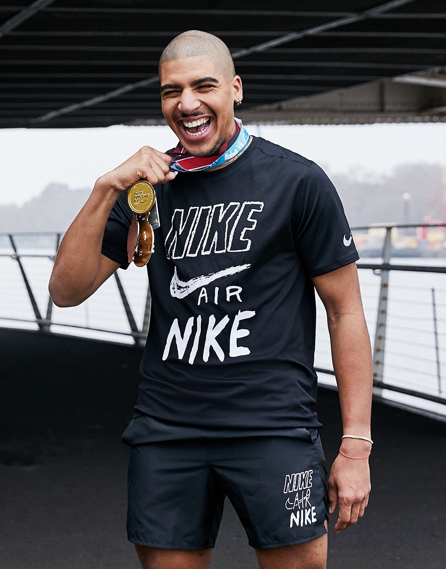 A picture of a man wearing a black T-shirt and shorts set from Nike Running. Available at ASOS.