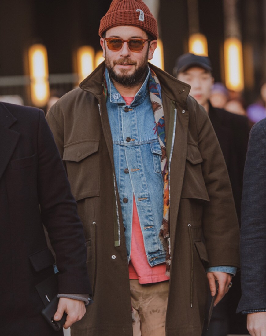A picture of a street styler in a tonal, layered outfit.