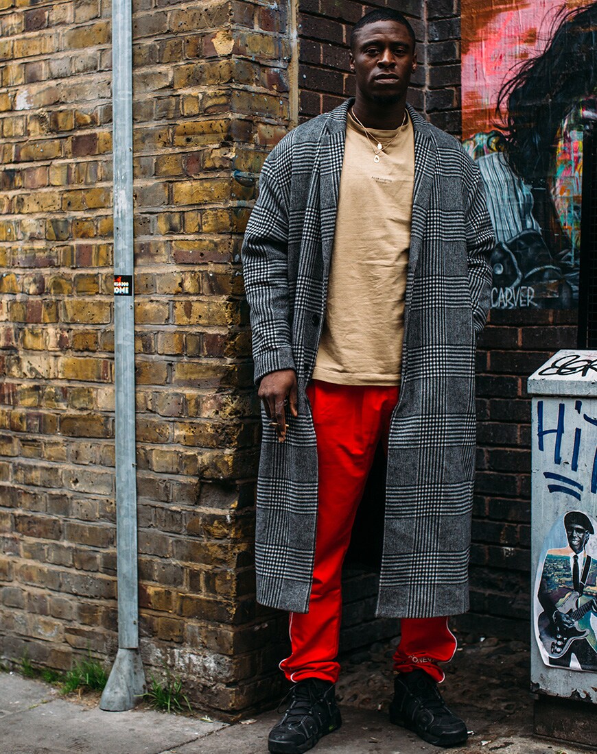 A picture of a street styler in a tonal, layered outfit.