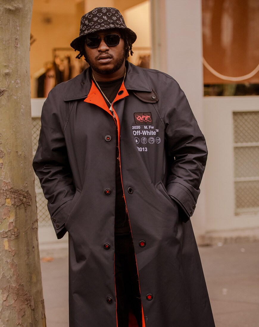 A picture of a man wearing a Prada mac with a neon lining.